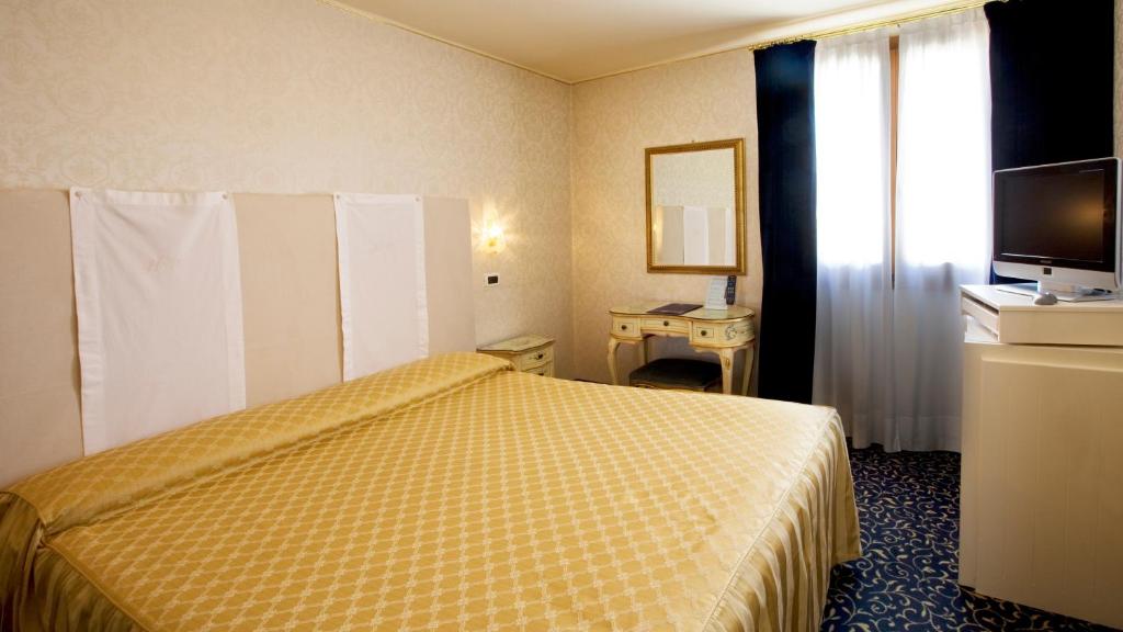 Postel nebo postele na pokoji v ubytování Hotel Principe