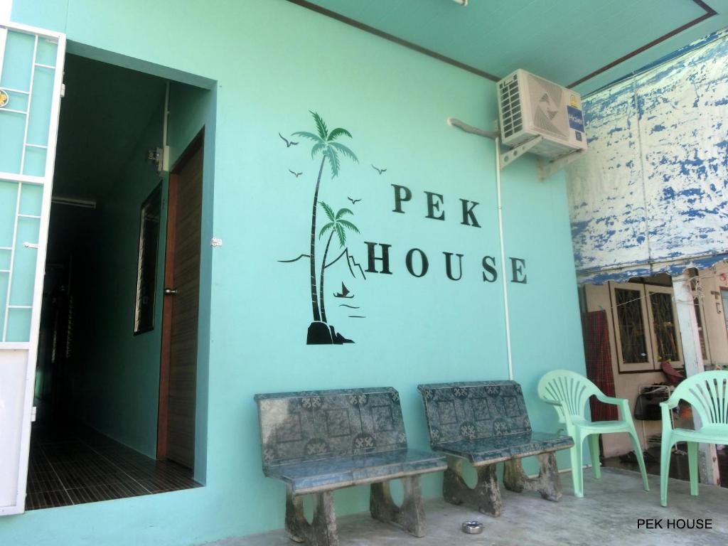 a blue wall with a sign that reads pet house at Pek House in Phuket