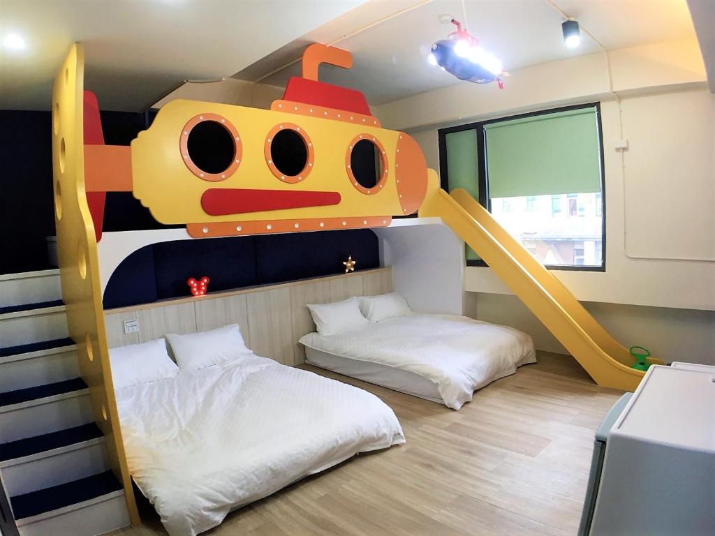 a childrens room with a bunk bed and a train mural at 23 Here B&B in Hualien City
