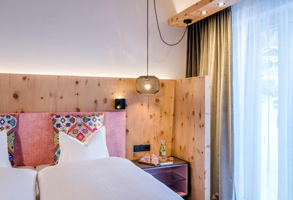 Postel nebo postele na pokoji v ubytování "Quality Hosts Arlberg" Hotel zur Pfeffermühle
