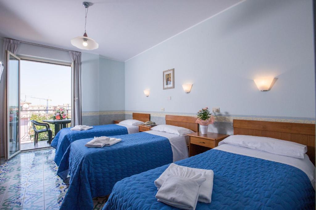 Postel nebo postele na pokoji v ubytování Hotel Casa Tra Noi