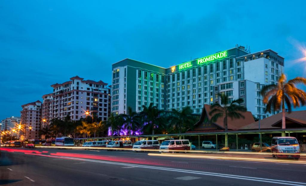 a building with a sign on it on a city street at Promenade Hotel Kota Kinabalu in Kota Kinabalu