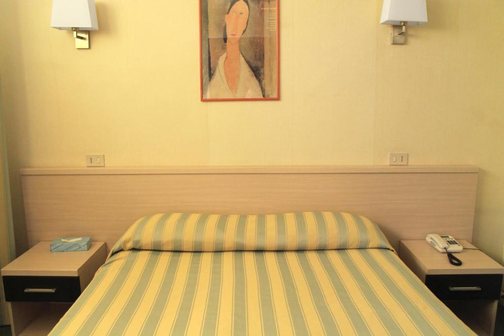 a hotel room with a bed and a telephone at Hotel Villa Delle Rose in Rome