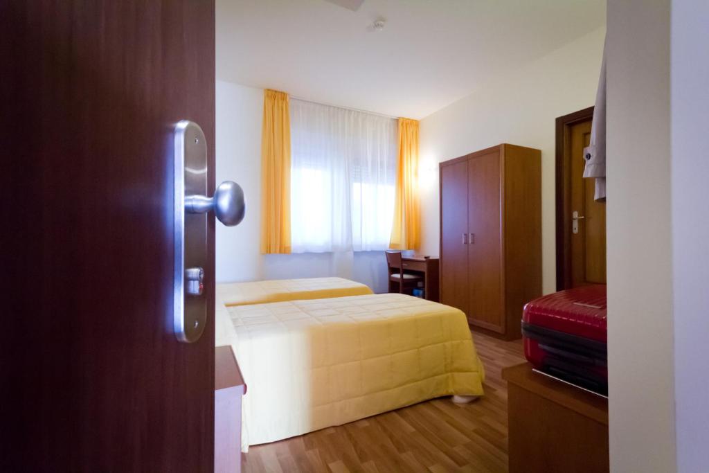 Postel nebo postele na pokoji v ubytování Hotel Donnini