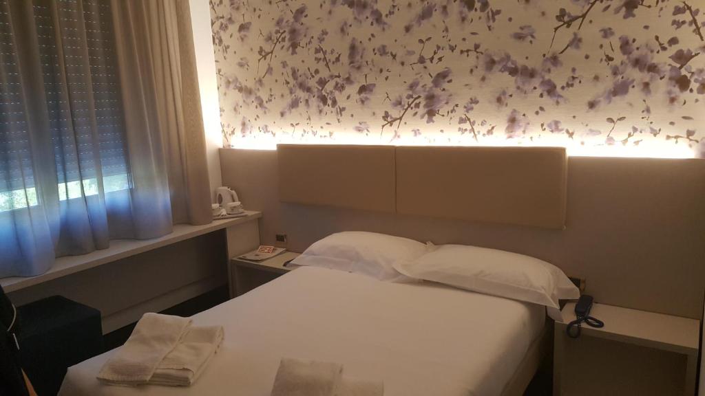 Postel nebo postele na pokoji v ubytování Hotel Augustus