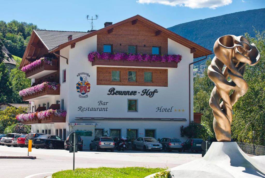 a building with a statue in front of it at Brunnerhof Klausen-Chiusa in Chiusa