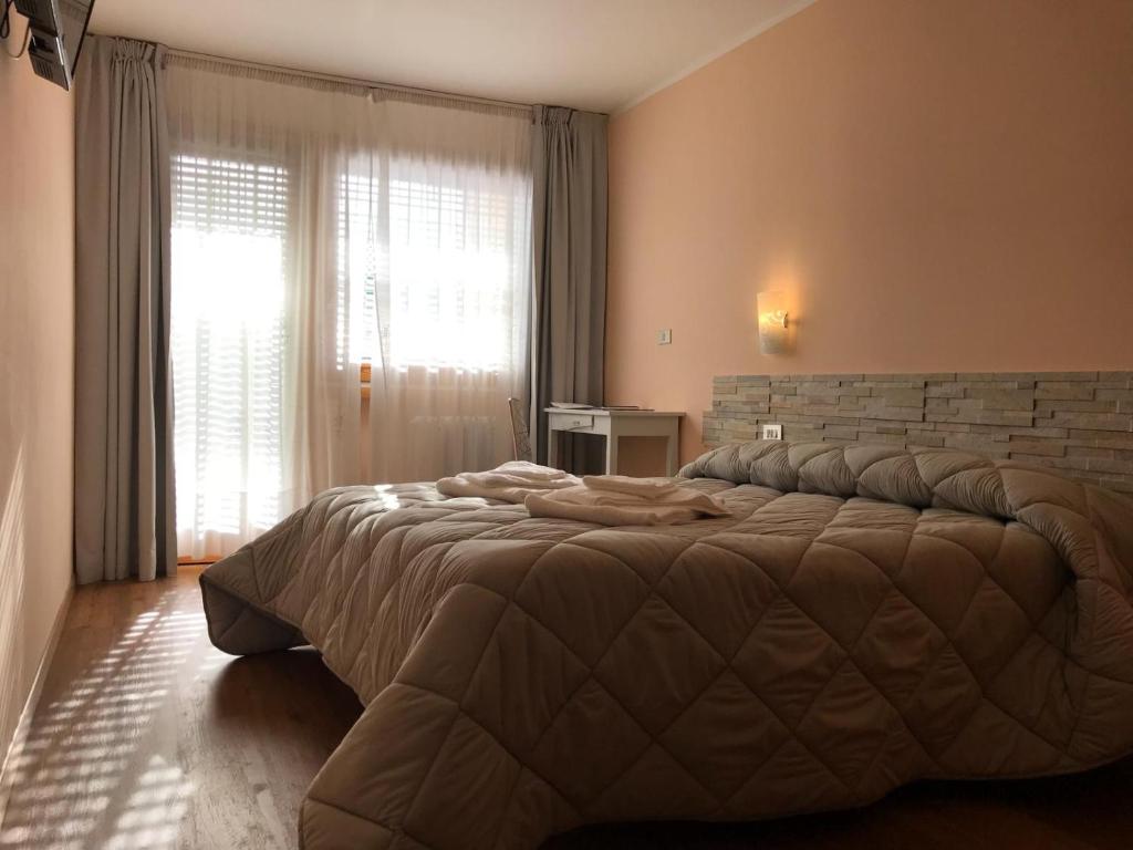 Postel nebo postele na pokoji v ubytování Hotel Olimpic