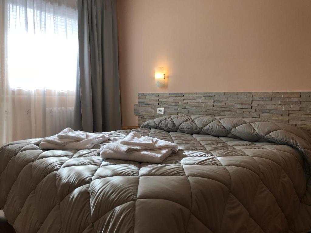 Postel nebo postele na pokoji v ubytování Hotel Olimpic