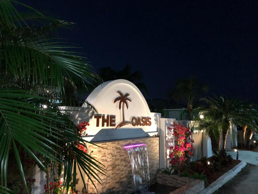 a building with a sign that says the class at The Oasis Retreat in Nassau