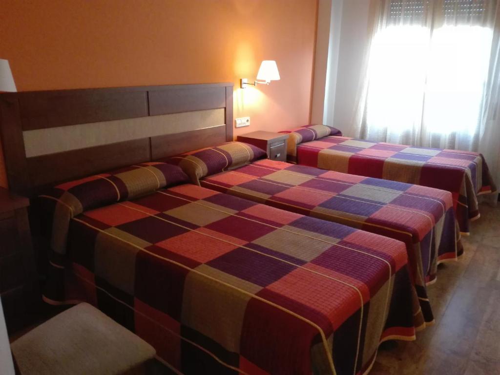 Posteľ alebo postele v izbe v ubytovaní Hostal Patrón