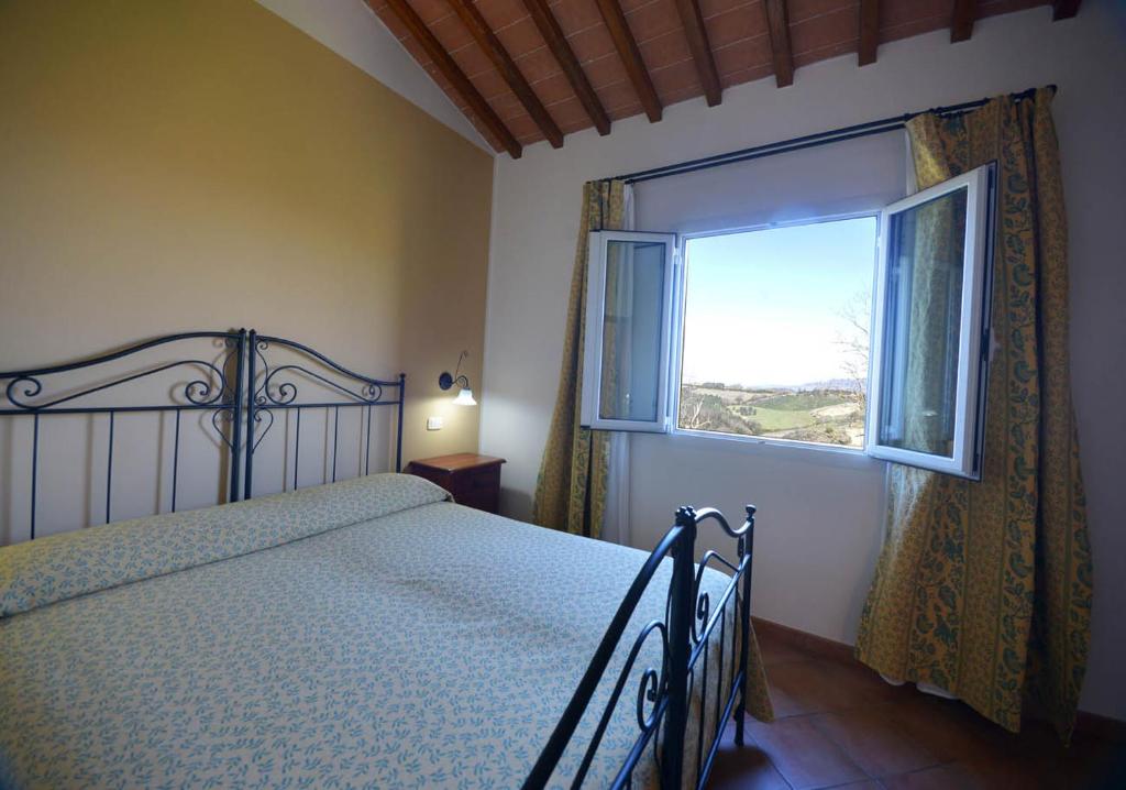 Postel nebo postele na pokoji v ubytování Agriturismo L'Imposto