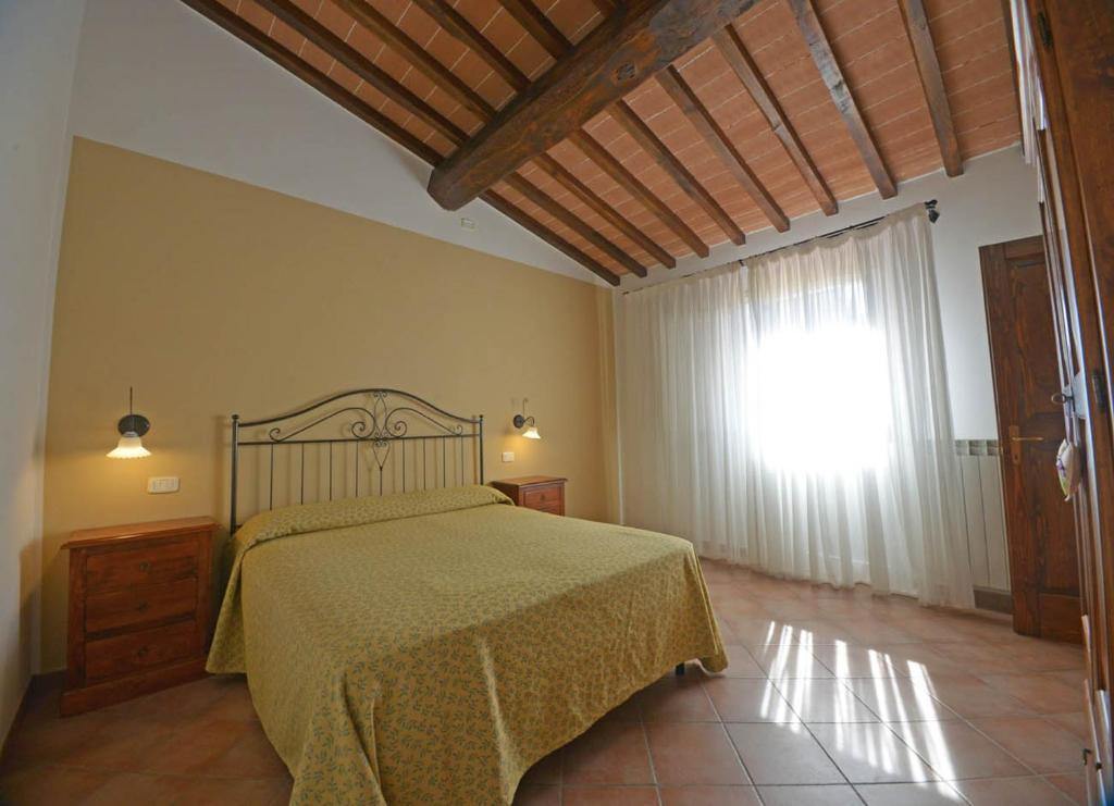 Postel nebo postele na pokoji v ubytování Agriturismo L'Imposto