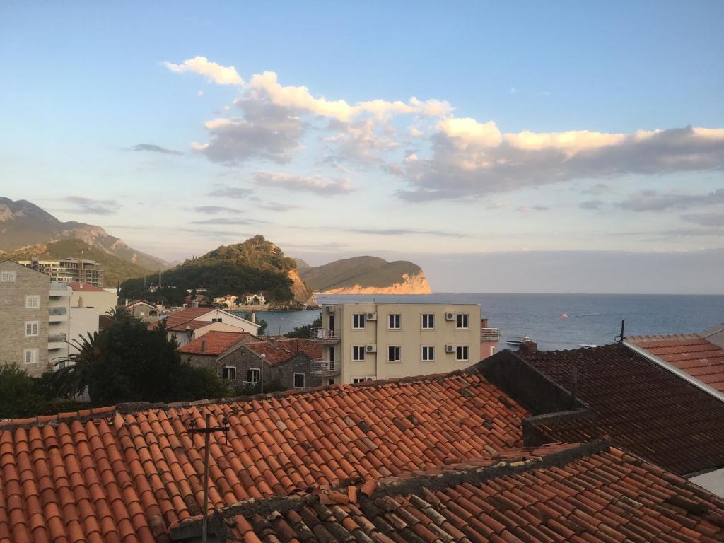 a view of the ocean from the roofs of buildings at Holiday Home Fisherman's in Petrovac na Moru