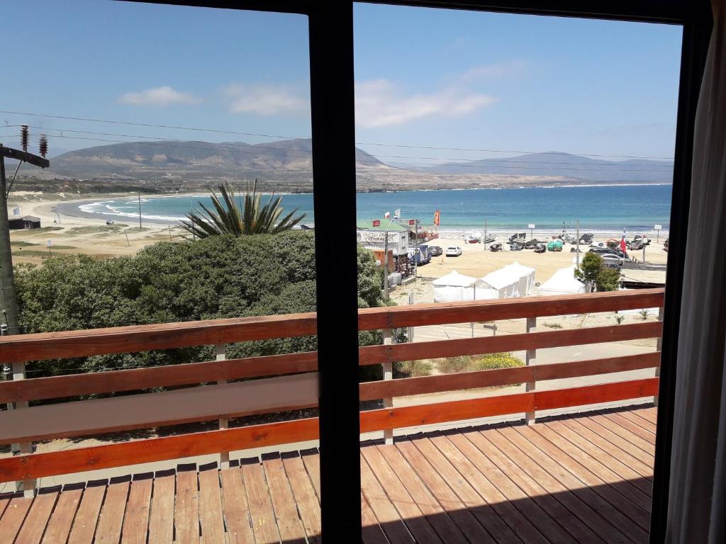 a view of the beach from the balcony of a house at Casa de playa Los Molles 833 in Los Molles