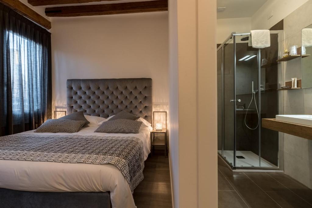 una camera con letto e doccia in vetro di La Loggia della Luna a Venezia