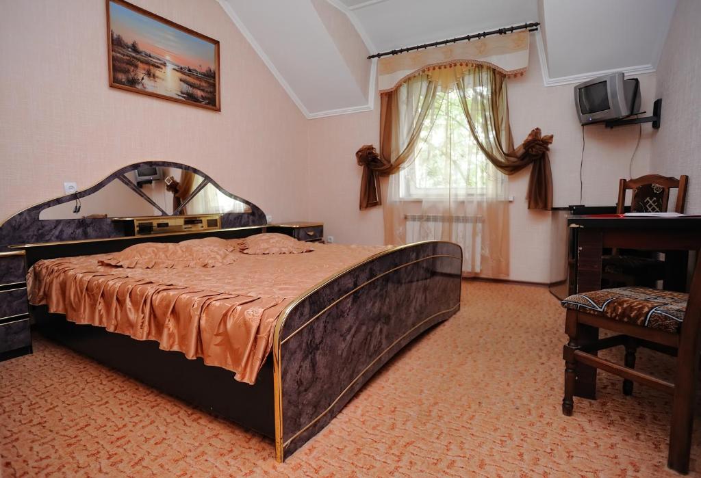a bedroom with a large bed and a mirror at Hotel Star in Stryi