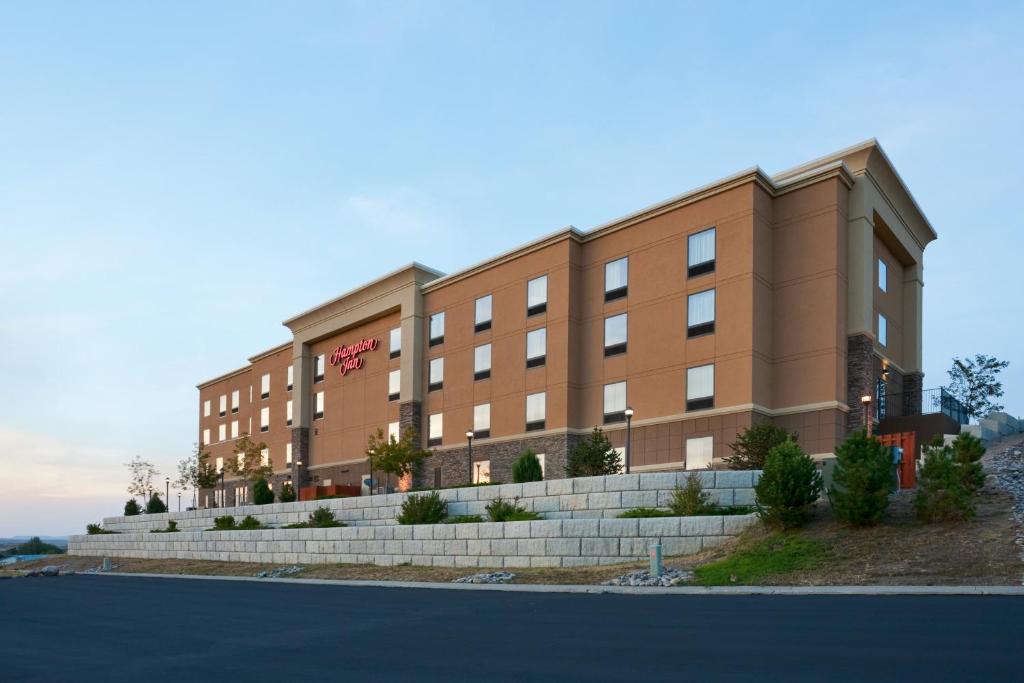 a large brown building with a staircase in front of it at Hampton Inn Sheridan in Sheridan