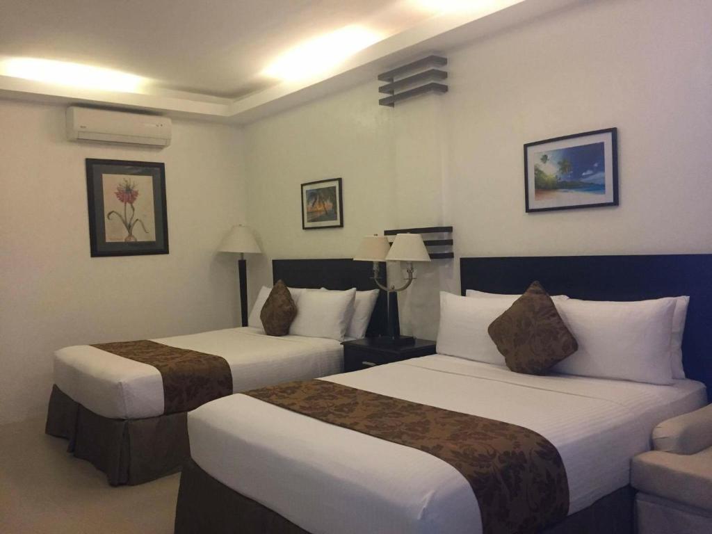 Postel nebo postele na pokoji v ubytování Chateau De Boracay