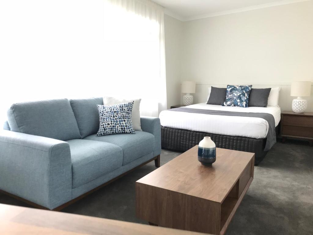 a living room with a couch and a bed at Orford Blue Waters Hotel in Orford