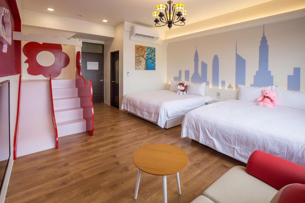 ein Hotelzimmer mit 2 Betten und einem Sofa in der Unterkunft Township Small Building B&B in Dongshan