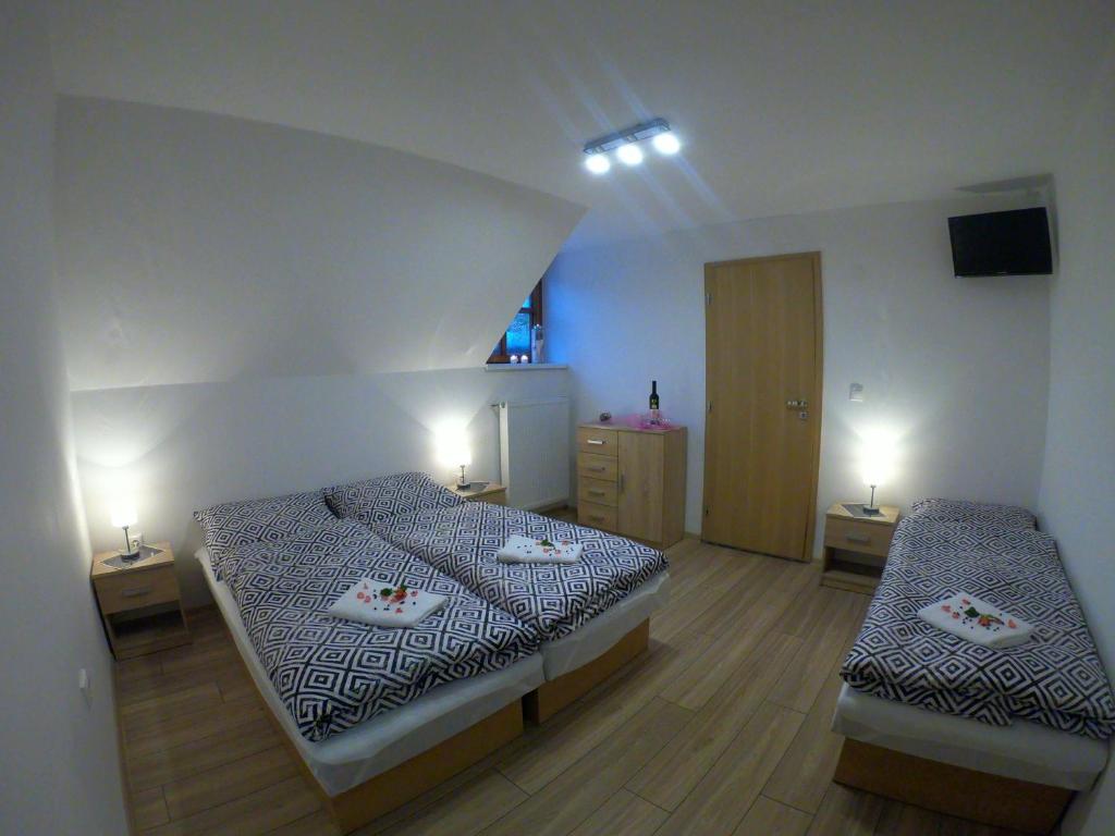 a bedroom with two beds and two night stands at Pizzéria Viktória in Chlebnice