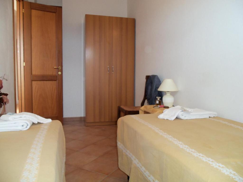 A bed or beds in a room at Appartamenti Galatea