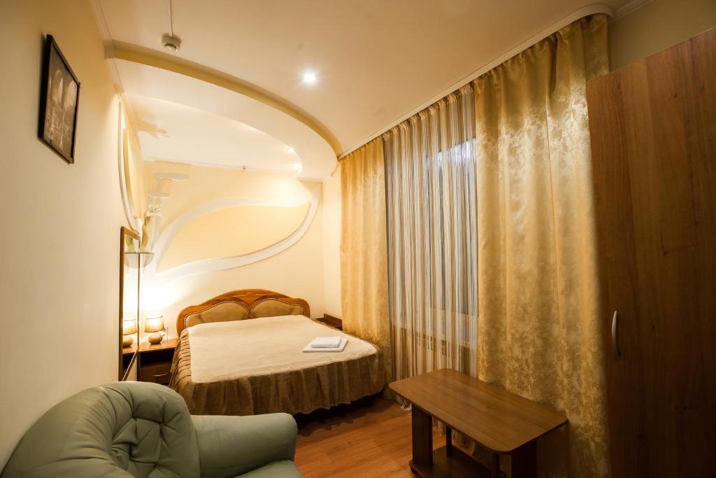 a hotel room with a bed and a table at Barabulka Hotel in Sevastopol