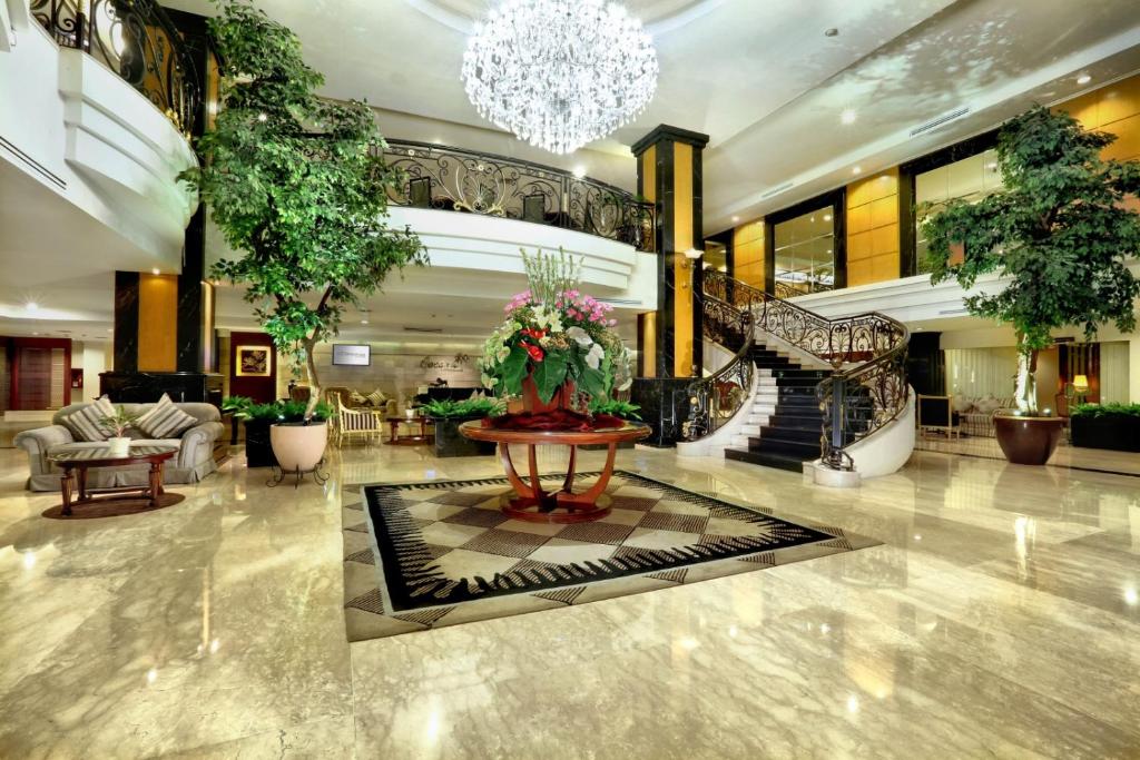 a lobby with a large building with a chandelier at ASTON Tropicana Hotel Bandung in Bandung