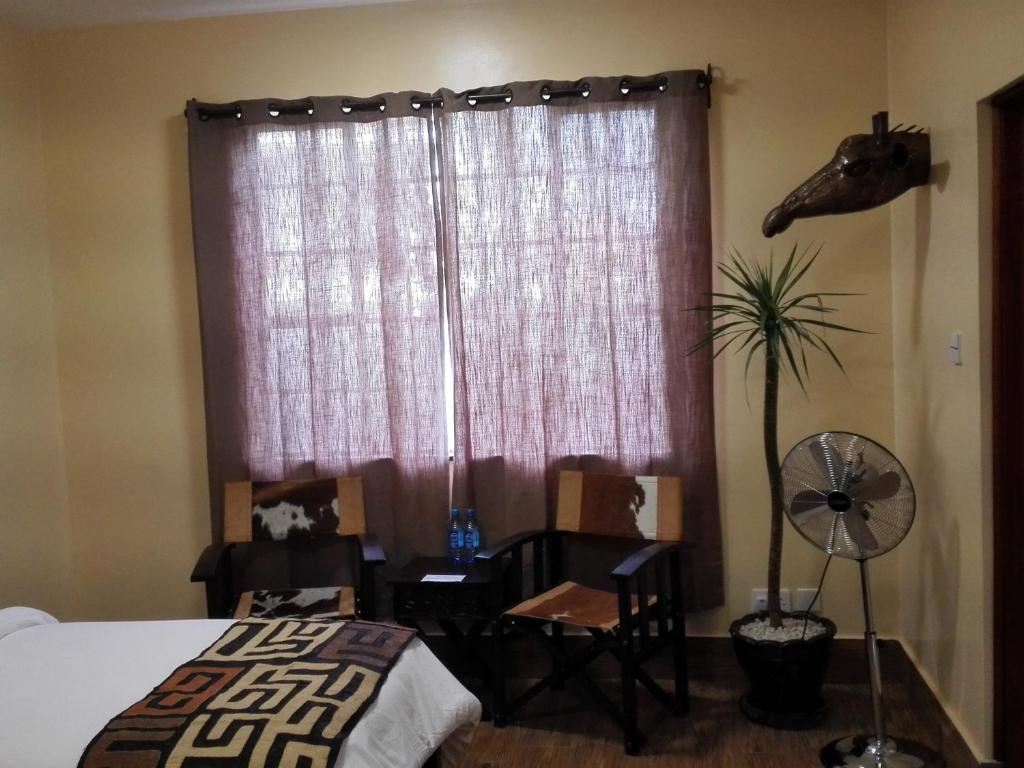 Postel nebo postele na pokoji v ubytování Acacia Tree Lodge