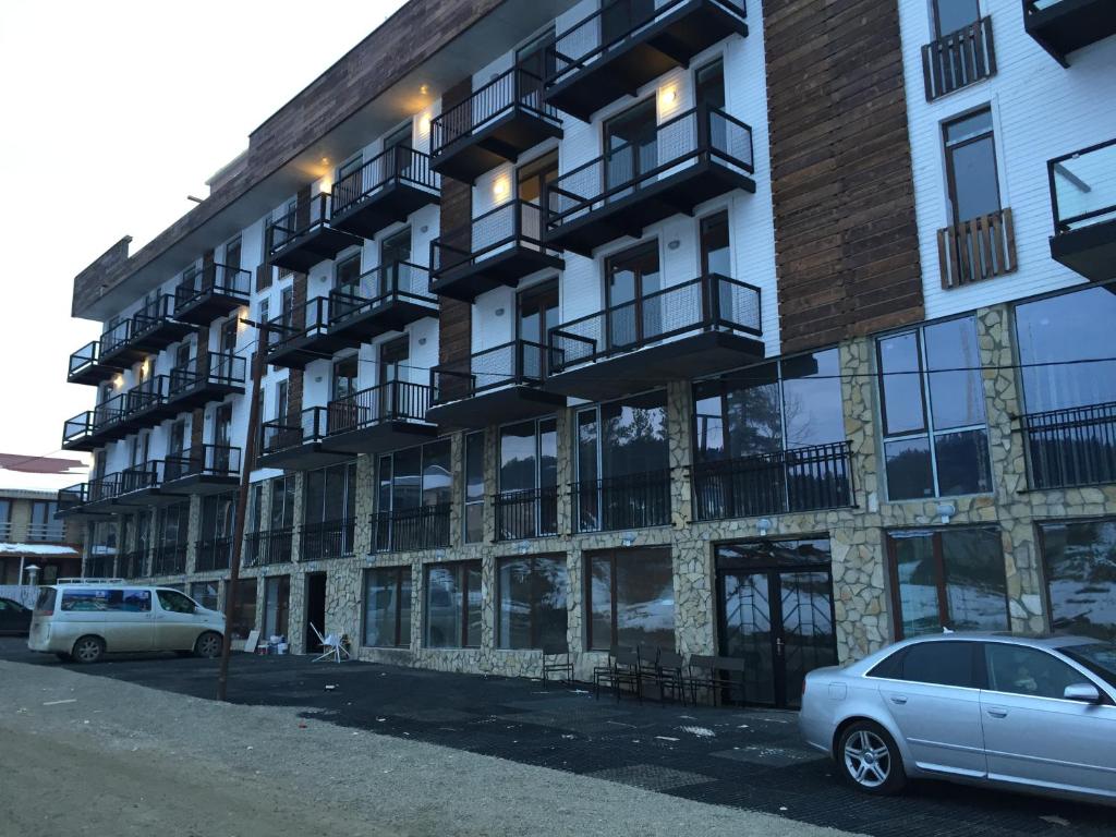 a building with cars parked in front of it at Ski Resort Bakuriani in Bakuriani