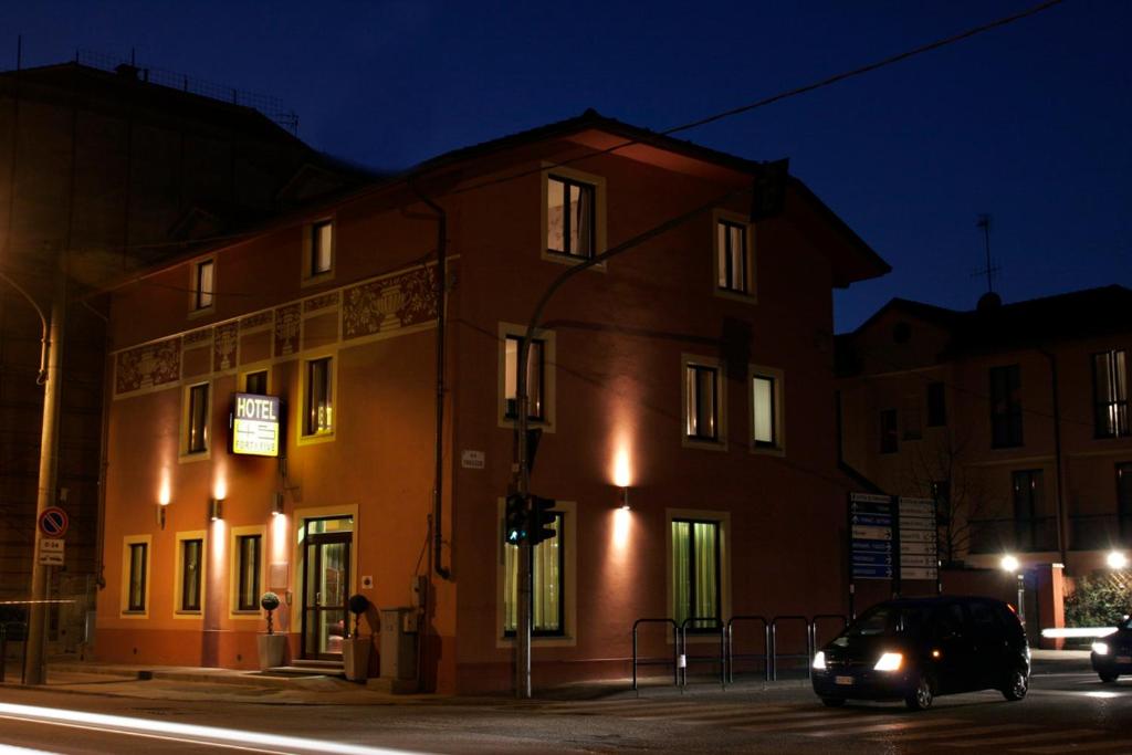 a building on the corner of a street at night at Hotel Fortyfive in Chivasso