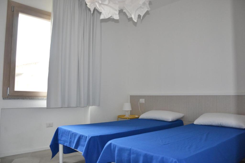 Łóżko lub łóżka w pokoju w obiekcie Le Perle dell'Isola