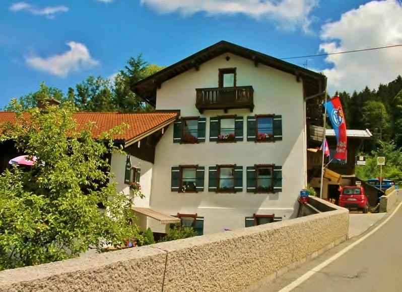 a white house with a balcony and a fence at Rottl-Sepp Renoth Karoline in Berchtesgaden