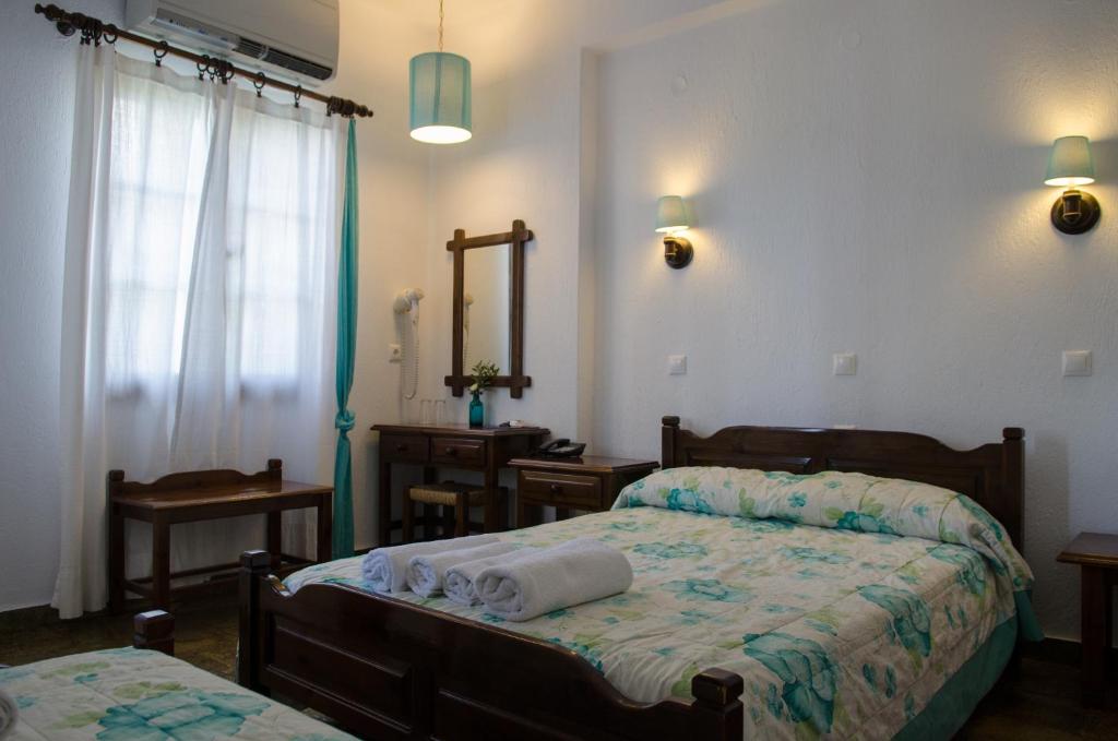 Postel nebo postele na pokoji v ubytování Elli Hotel
