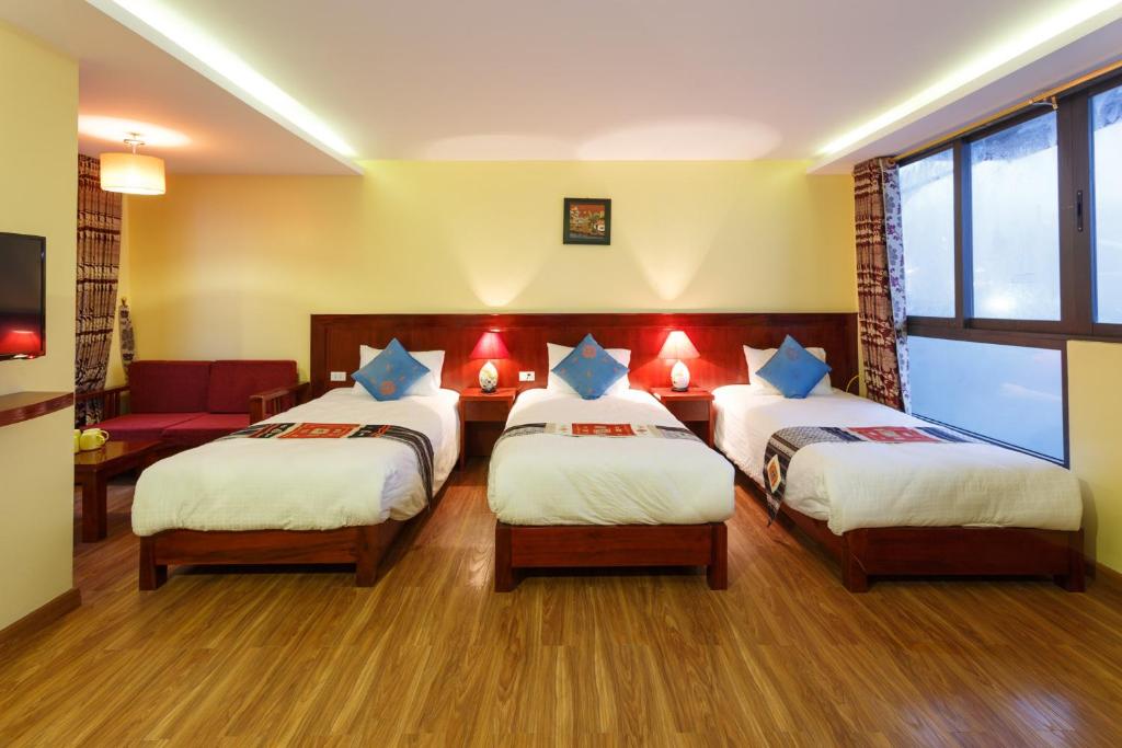 Postel nebo postele na pokoji v ubytování Anise Sapa Hotel