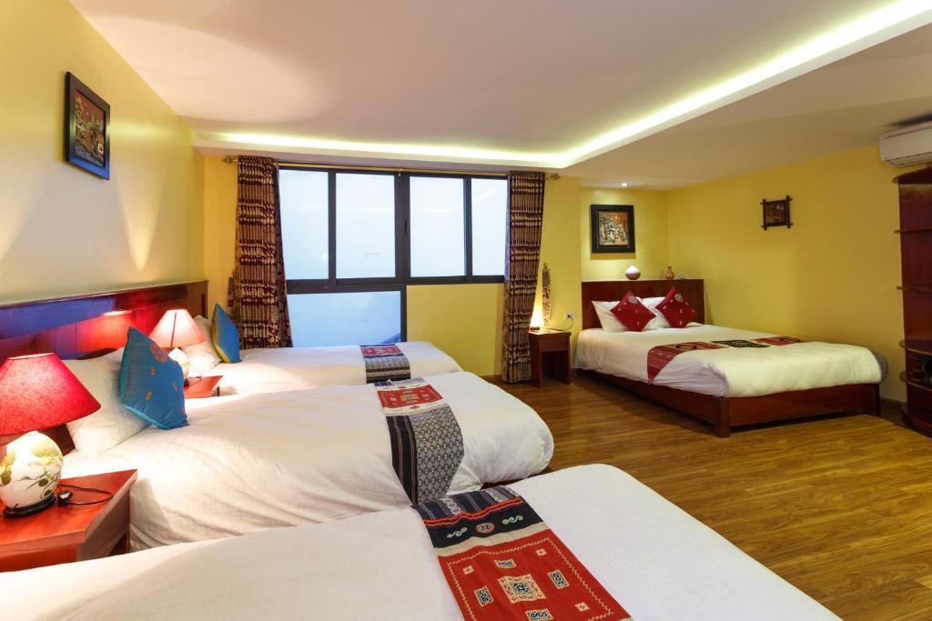 Postel nebo postele na pokoji v ubytování Anise Sapa Hotel