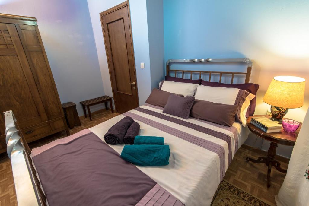 a bedroom with a bed with two pillows on it at Lampreiko in Synikia Mesi Trikalon