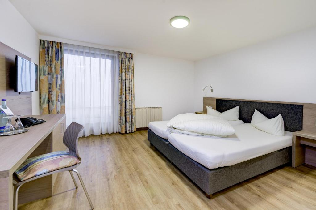 Postel nebo postele na pokoji v ubytování Hotel Rose