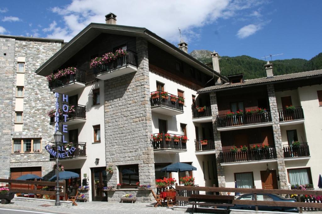 a large building with flowers on the balconies of it at Hotel Al Caminetto in Valtournenche