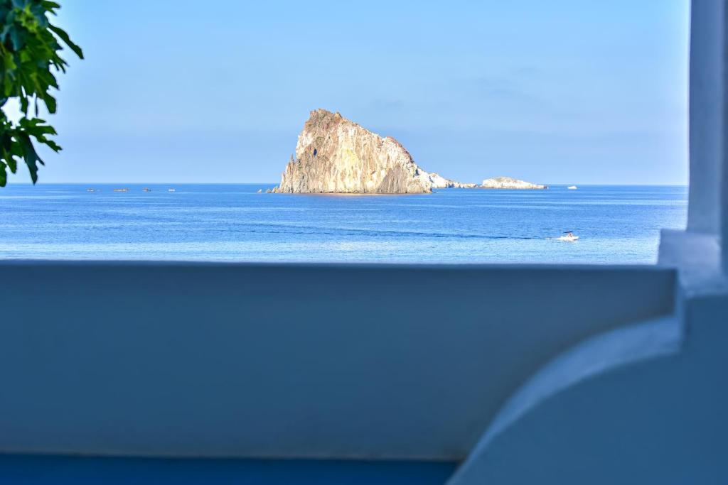 a view of the ocean with an island in the distance at Hotel Eunymos in Panarea