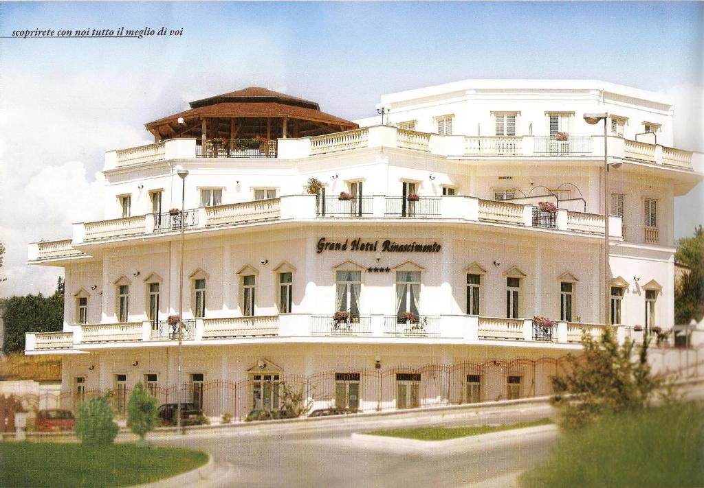 a large white building with balconies on it at Hotel Rinascimento in Campobasso