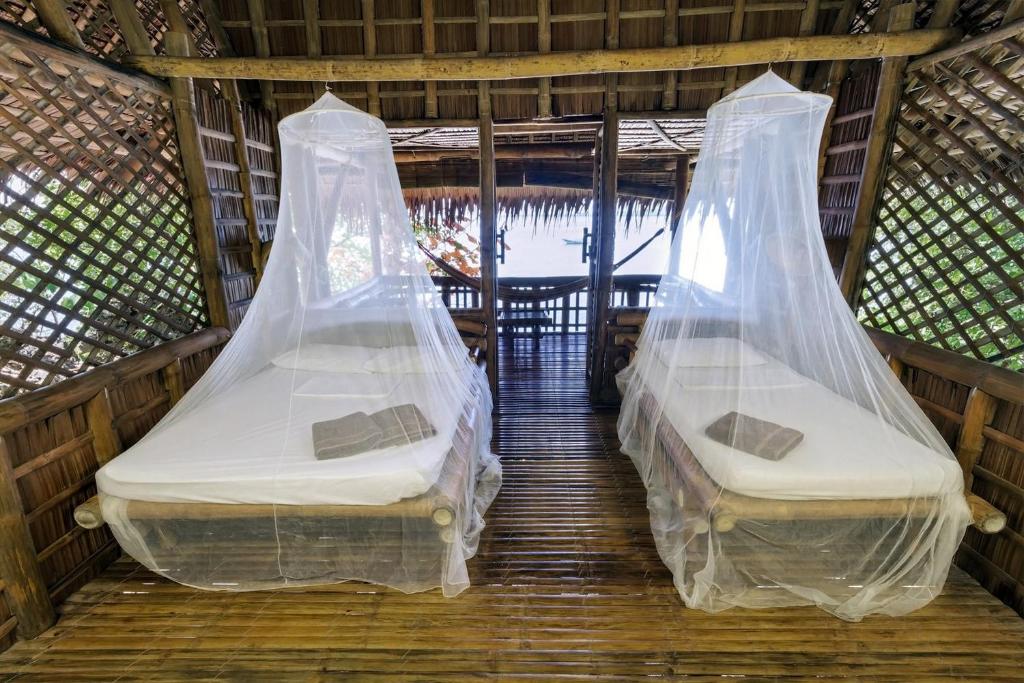 Postel nebo postele na pokoji v ubytování Kookoo's nest eco-lodge