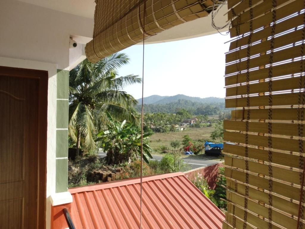 a view from the balcony of a house at Green Villa in Virajpet