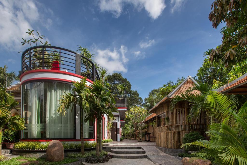 a home with a red and white house at De Sarann Villa in Siem Reap