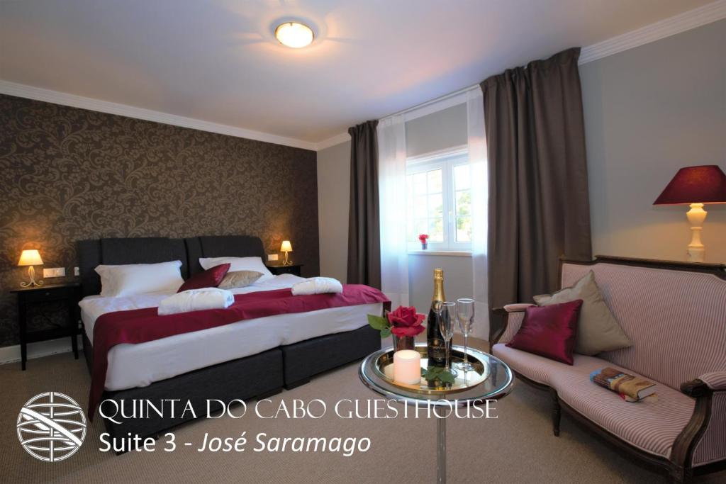 a hotel room with a bed and a couch at Quinta do Cabo Guesthouse in Sintra