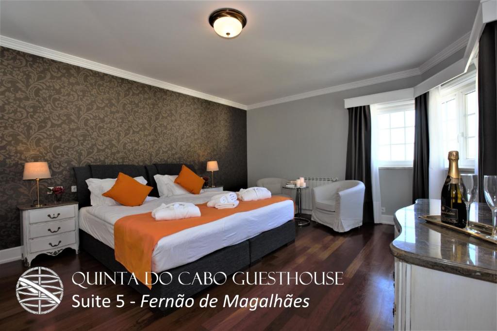 a hotel room with a bed with orange pillows at Quinta do Cabo Guesthouse in Sintra