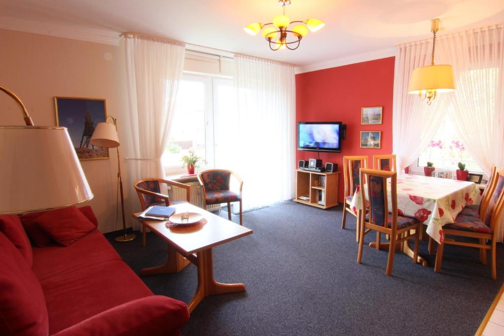 a living room with a couch and a table at Residenz Albatros in Cuxhaven