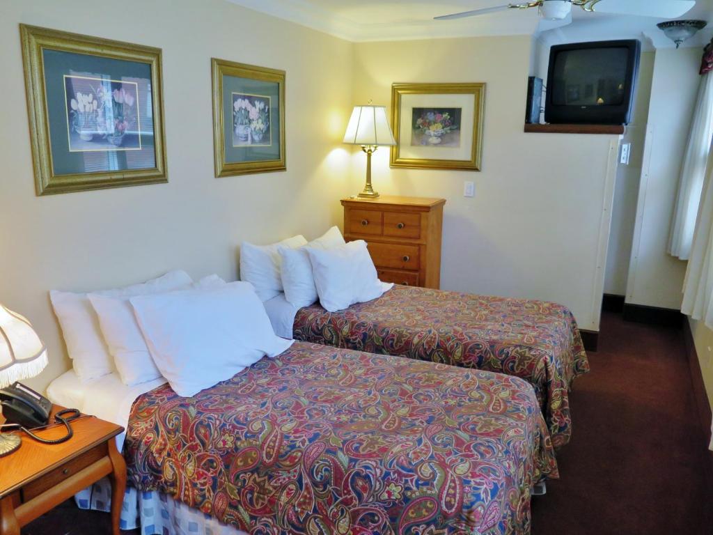 Postel nebo postele na pokoji v ubytování Madison Manor Boutique Hotel