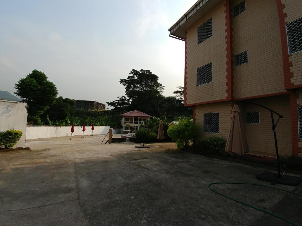 an empty parking lot next to a building at Rose Garden Apartments in Limbe