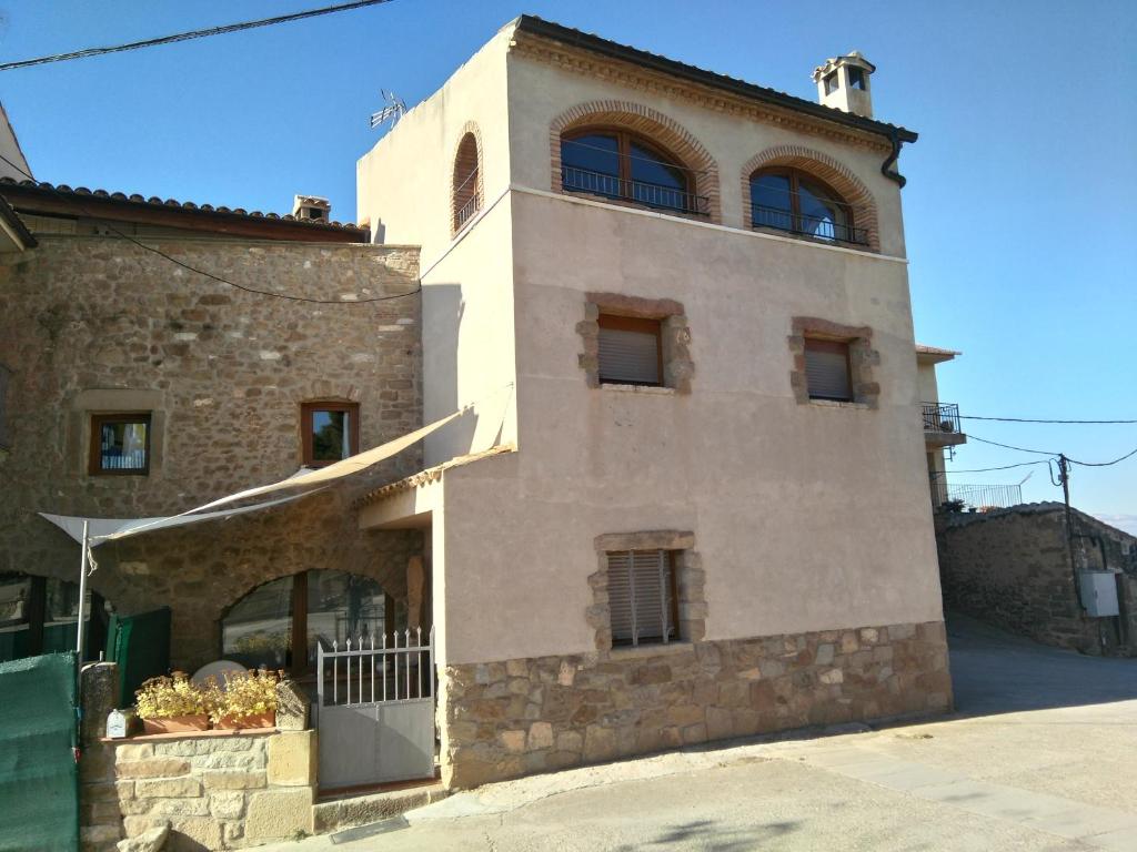 a building with two windows on top of it at La Rectoria in Coscó 